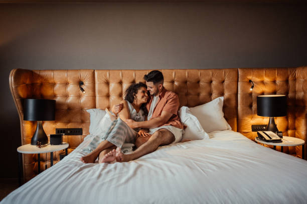 istock Couple on vacation in hotel bed 2188361496