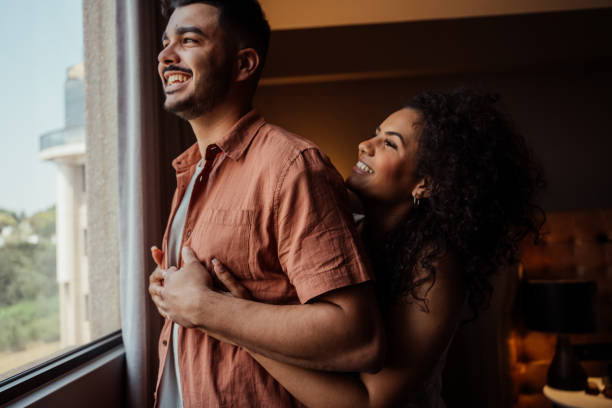 istock Couple in hotel room window 2188361549