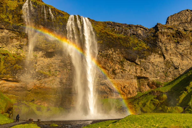 the skogafoss waterfall in southern iceland, inside the famous golden circle surrounded by a splendid double rainbow.