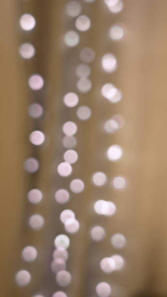 istock Classic blurred golden and brown bokeh with glowing Christmas light charm. 2188364522