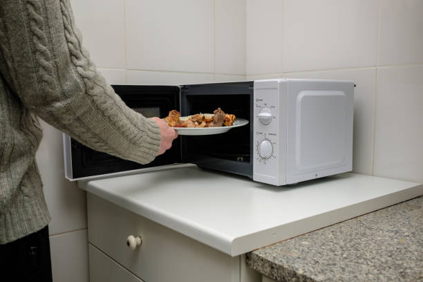 Man heating food in the microwave