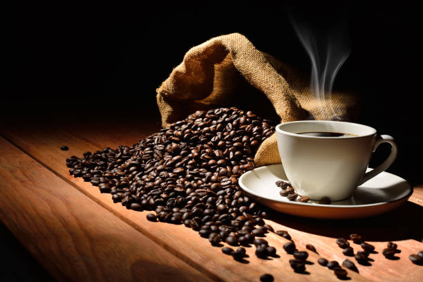 istock Coffee cup and coffee beans on old wooden table 2188367137