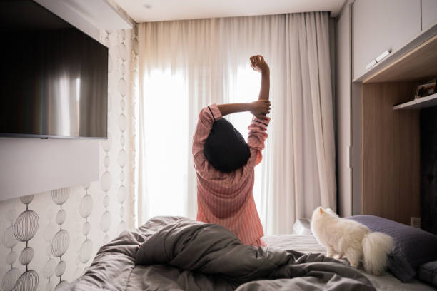 istock Mid adult woman stretching upon waking up 2188367848