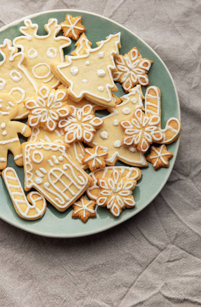 istock Christmas cookies with white icing forming various shapes lying on a plate 2188369817