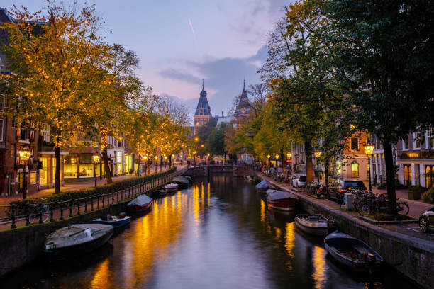 istock Autumn evenings in Amsterdam: Canals illuminated by warm lights and fall foliage glow 2188369861
