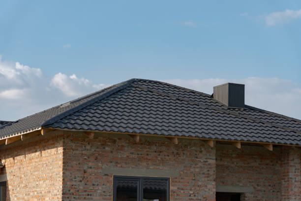 istock A contemporary rooftop featuring metallic tiles crowns a newly constructed residential building, enhancing its modern architectural appeal against a bright sky 2188370156