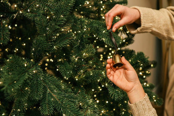 istock Parent and child decorating a Christmas tree together, holding hands while hanging an ornament. A warm and emotional family moment captured during the holiday season 2188371637