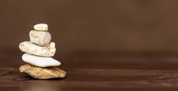 istock Balancing stones on brown background, life coaching banner 2188373228