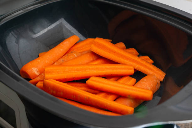 istock Carrots neatly arranged in the steaming basket of a kitchen food processor. 2188374656