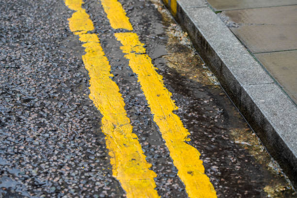 istock Double yellow lines on a wet road 2188375357