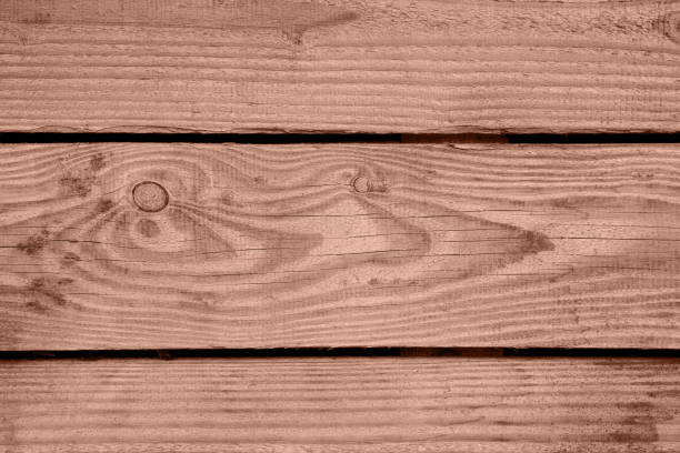 Background of horizontally arranged wooden boards with visible nail heads, wood texture and knots. Light wooden texture.