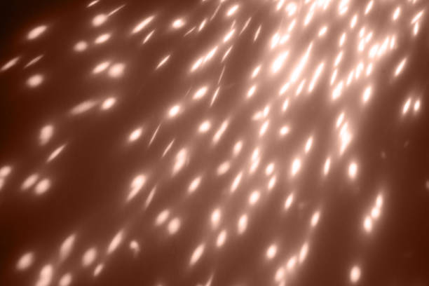glowing sparkles closeup on dark background. Holiday background overlay color of 2025 year