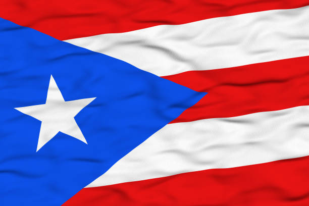 The national flag of Puerto Rico depicted waving in the wind, featuring red and white horizontal stripes, a blue triangle, and a single white star. This flag represents the territory's culture, identity, and pride.