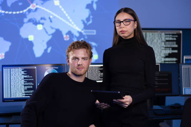istock Professional serious cyber security team in front of cybersecurity SIEM system with logs and incident map 2188378986