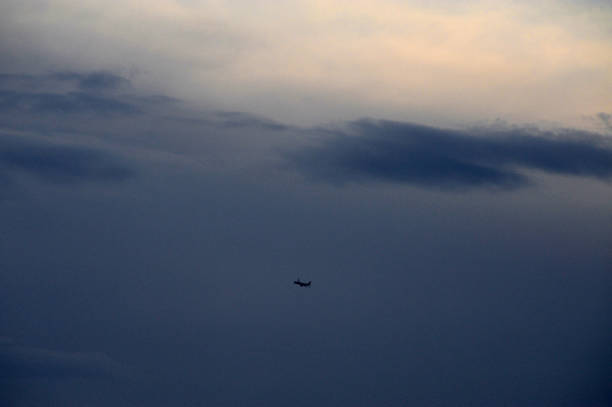 istock A plane is currently flying high through a cloudy sky above 2188382032