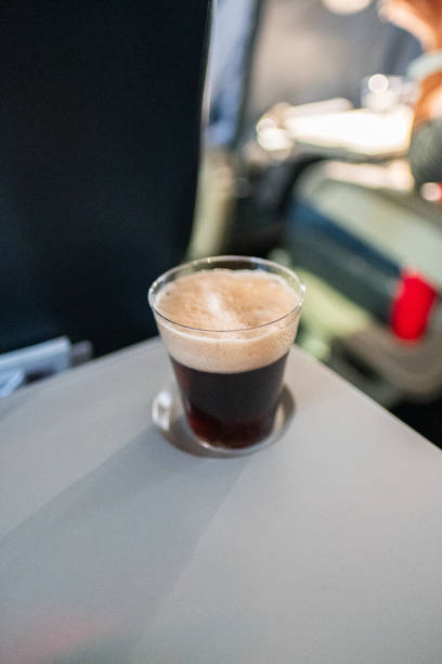 Relaxing Flight Experience with a Refreshing Glass of Cola Served Onboard an Airplane in Comfortable Seating Area
