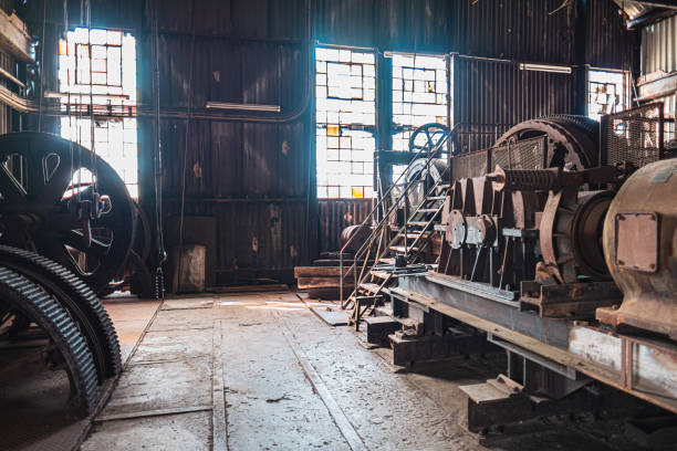 istock Rustic Industrial Machine Room with Large Gears and Sunlight Streaming Through Grimy Windows in a Historical Factory Setting, Emphasizing Heritage and Vintage Engineering Design Elements 2188387930