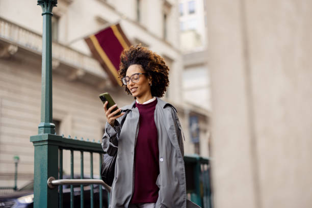 istock Business Woman Enjoying City Life While Using Phone in Urban Setting 2188388518