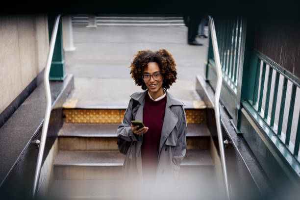 istock Businesswoman Using Smartphone While Exiting Subway in Urban Environment 2188388527