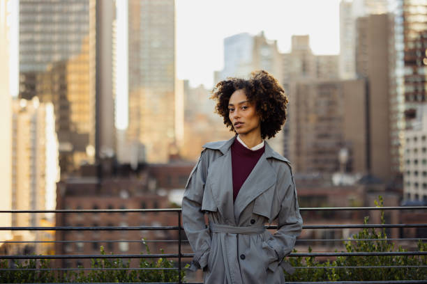 istock Confident Woman in Trench Coat on New York City Rooftop 2188388564