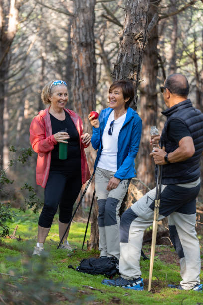 istock Group of Senior Friends Taking a Break While Hiking in the Forest 2188388911