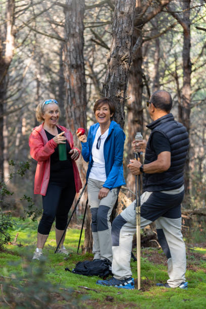 istock Group of Senior Friends Taking a Break While Hiking in the Forest 2188388914