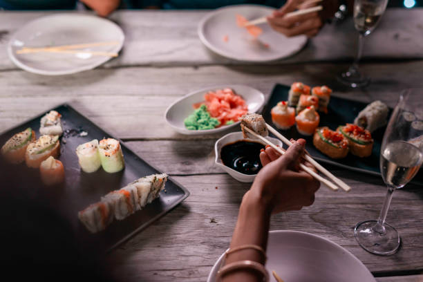 istock Elegant Sushi Dinner Party With Assorted Dishes and Champagne Under Warm Ambient Lighting 2188389129