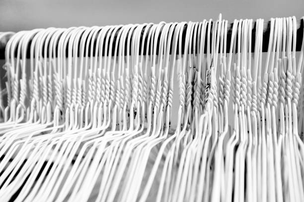 Hangers on pole for hanging clothing in closet storage Many several metal wire hangers on pole for hanging clothing in closet storage clothes hanger rod stock pictures, royalty-free photos & images