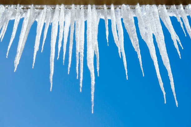 istock Icicles Hanging from Rooftop of Home Melted Ice Dripping 2188389237