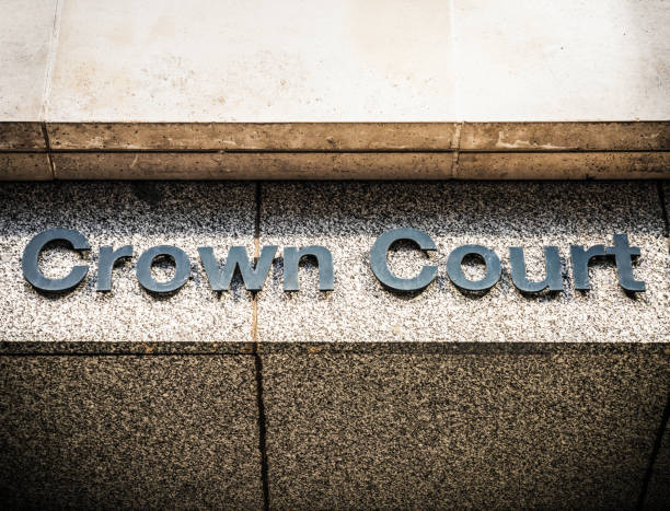 Close-up of the text 'Crown Court' on a building sign in central Manchester, UK.