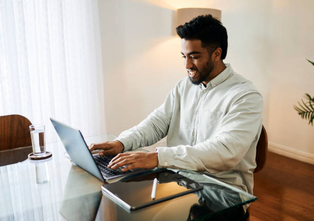 istock Happy Young Man Working on Laptop at Desk 2188392549