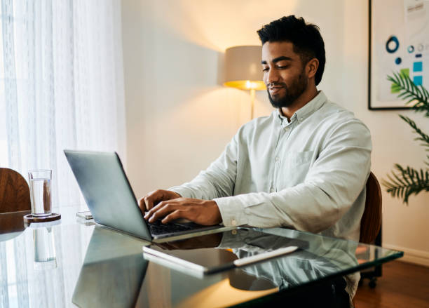 istock Happy Young Man Working on Laptop at Desk 2188392566