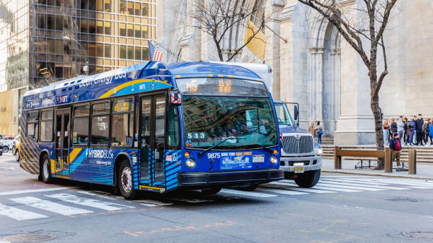 Manhattan, New York, USA - February 15, 2023: Typical bus driving in the city center on a sunny winter day