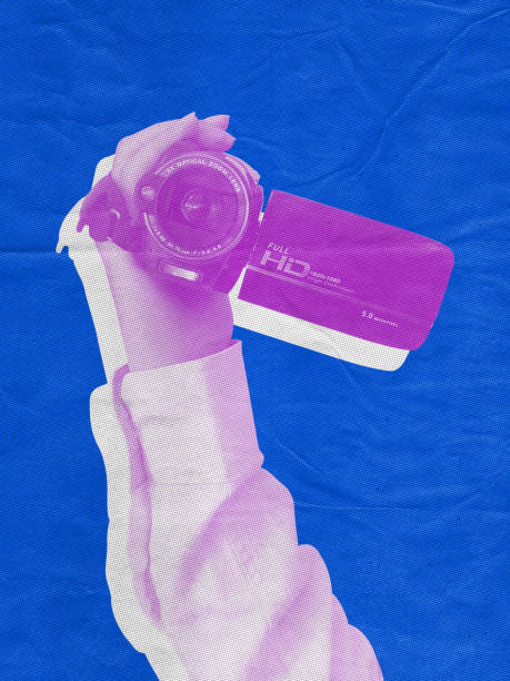 Hand holding old digital camera recorder pop art style