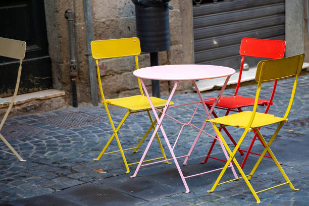 istock There is a table and some chairs placed on a cobblestone street 2188395636