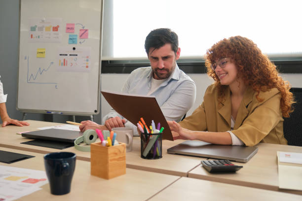 istock Business people working together in office reading documents 2188395690