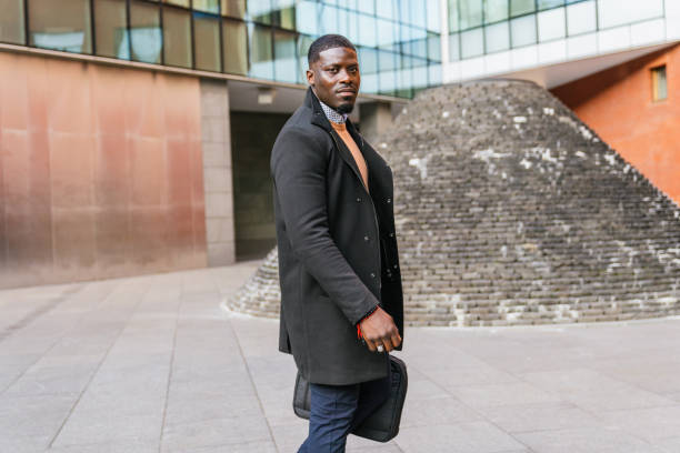 istock Confident businessman walking outside office building 2188396039