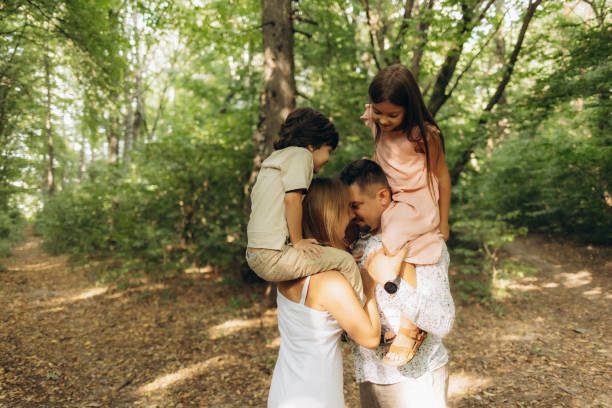 istock parents with their son and daughter having fun in nature 2188396426