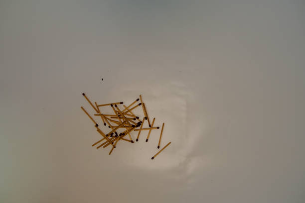 Wooden matches scattered on a white background.