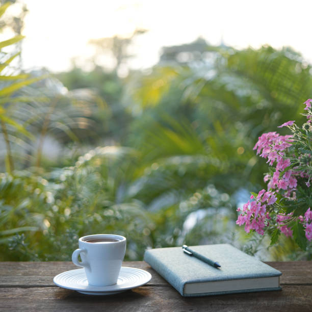 istock A White tea cup with Verbena flower and notebook, outdoor working 2188399184