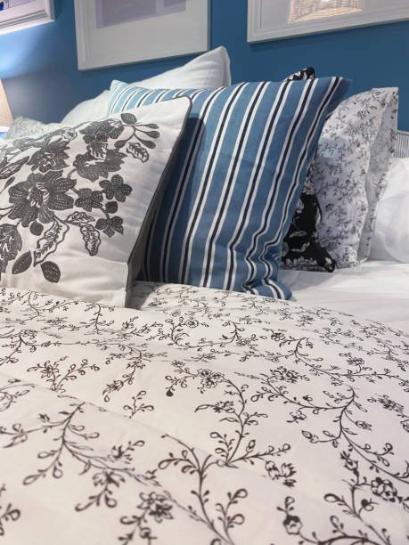 istock bed in bedroom with blue and white pillows 2188400721
