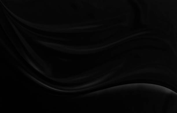 istock Black gray satin dark fabric texture luxurious shiny that is abstract silk cloth background with patterns soft waves blur beautiful. 2188401622
