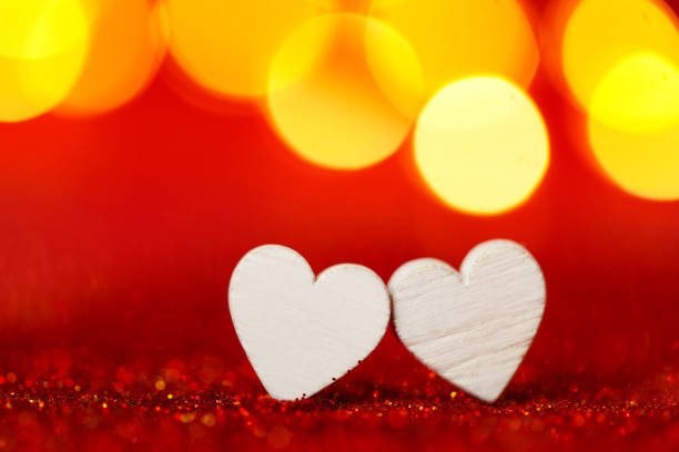 Valentines Day.Wooden Hearts on Sparkling Background