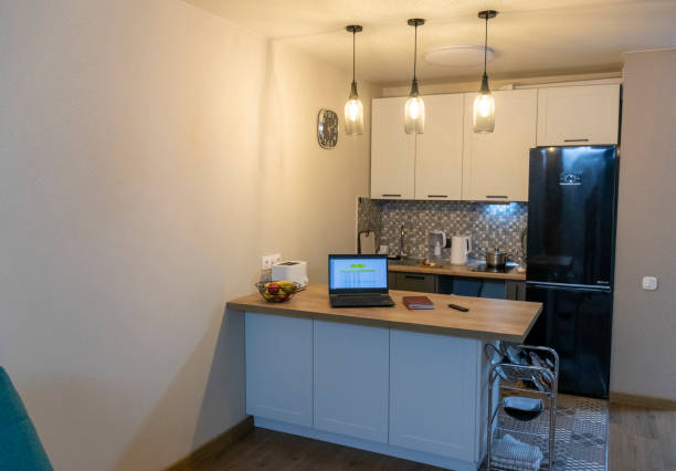 istock Laptop on the kitchen counter top with an excel sheet on computer screen showing bank loan amortization table. Concept 2188404586