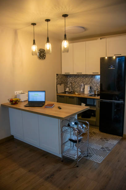 istock Laptop on the kitchen counter top with an excel sheet on computer screen showing bank loan amortization table. Finance 2188404589