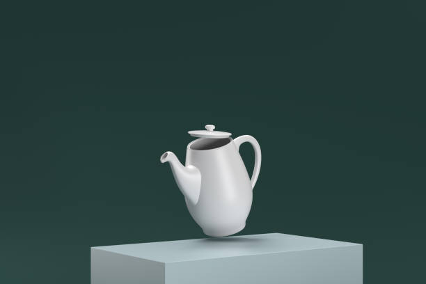 istock A white tea pot is sitting on a green surface 2188405990