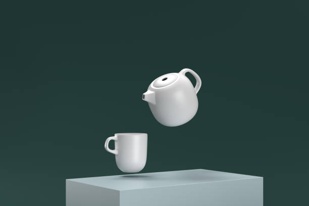 A white tea kettle is shown in mid-air, with a white cup below it