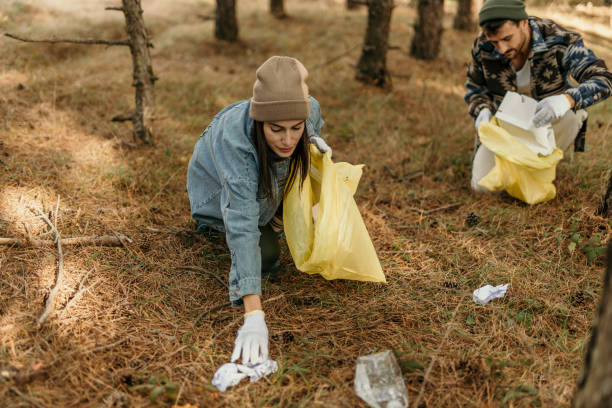 istock Picking up plastic bottles and trash in the woods 2188406371