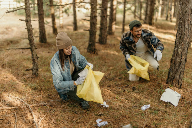 istock Picking up plastic bottles and trash in the woods 2188406373
