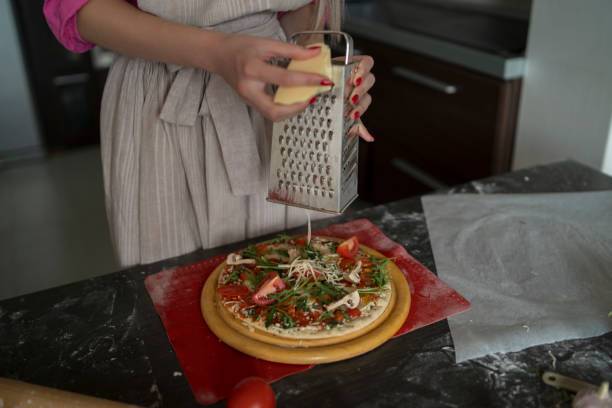 istock Woman preparing a tasty pizza 2188406426